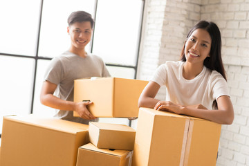 Couple helping pack the goods ordered online customers.