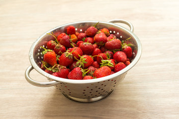 Fresh strawberries in a colander