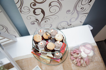 Photo of different cakes placed on a tree layered glass stand, view from above