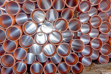 View trough arranged PVC tubes pipes stacked in rows pattern