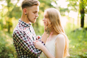 Fototapeta premium Beautiful Love story in the woods. Portrait of young stylish couple.