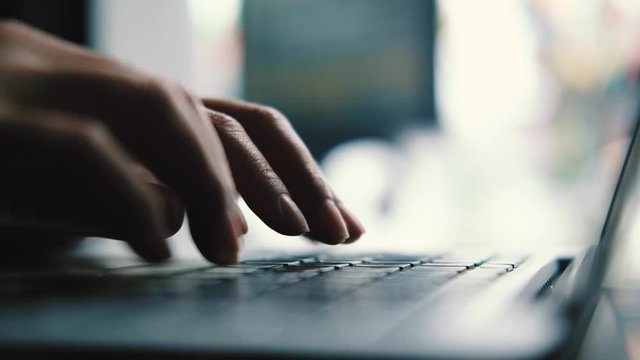 A  business woman's hands working and typing on laptop keyboard 