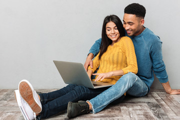 Pretty couple using laptop