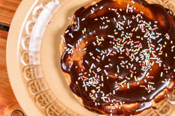Closeup macro of melting chocolate cream with colorful sprinkles