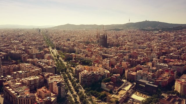 Barcelona cityscape and distant mountains on a sunny day, Spain