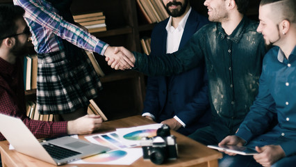advertising Manager with a handshake greets the customer