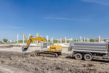 Excavator is digging on building site