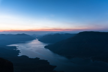 Fototapeta na wymiar Mae Ping river view point. Sunrise above the lake and mountain.