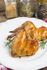 Baked chicken wings in pan on wooden table.