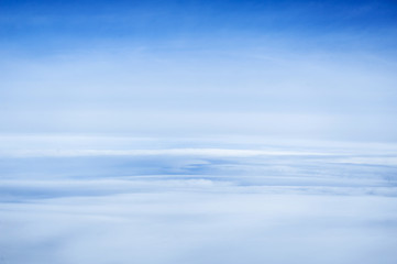 Clouds and sky as seen through window of an aircraft.