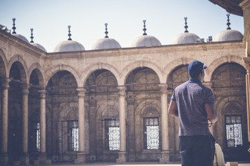 cairo, egypt, april 22, 2017: view from behind of black man at muhammad ali mosque at cairo citadel