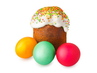 Easter cake with white cap of icing and colored powder, Painted easter eggs isolated on white background. Traditional Slavic festive homemade bread and eggs for the celebration of Orthodox Easter.