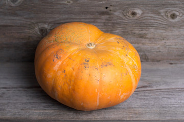 Ripe pumpkin on a wooden background