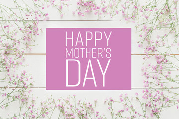 Mother's day background, white wooden table with pink flowers © andreaobzerova