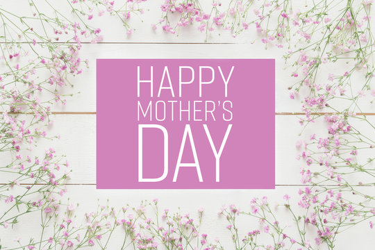 Mother's day background, white wooden table with pink flowers