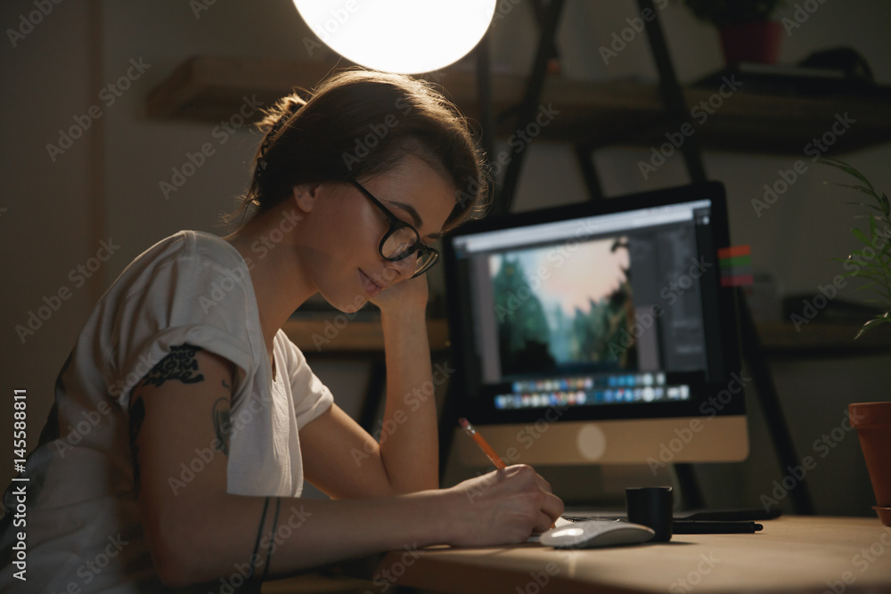 Poster Lady designer sitting indoors at night drawing sketches