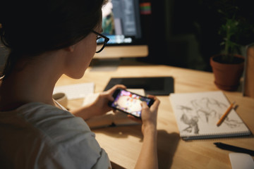 Cropped image of young lady designer play games