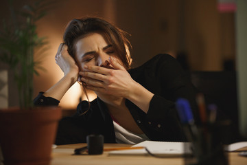 Woman yawning in office