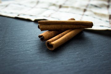 Rods of cinnamon on a dark background