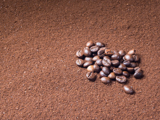 Fototapeta na wymiar Grinded coffee background with scattered grains from top view