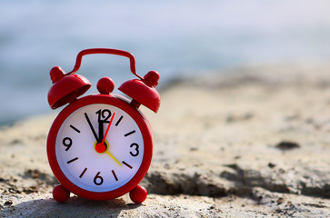 Vintage red clock showing 5 to 12