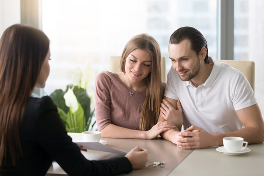 Young couple came to real estate agency to consult an expert, family ready to buy rent flat, considering bank loan for apartment purchase, taking mortgage credit, choosing place to live