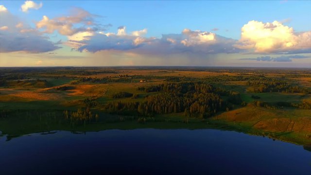 Drone flight over the lake and the fields in environs of Izbork