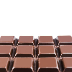 Fototapeta premium Bitter, dark chocolate bar, isolated on white background, close-up view with copy space