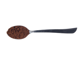 Steel spoon with grounded coffee over white isolated background