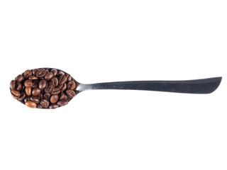 Steel spoon with coffee beans over white isolated background