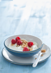 yogurt with granola and raspberry for healthy breakfast