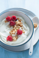 yogurt with granola and raspberry for healthy breakfast