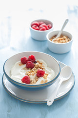 yogurt with granola and raspberry for healthy breakfast