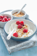 yogurt with granola and raspberry for healthy breakfast