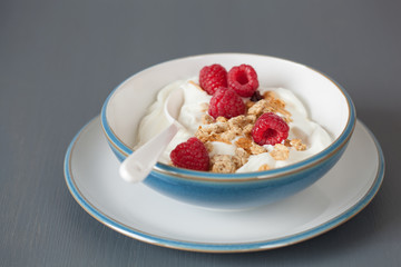 yogurt with granola and raspberry for healthy breakfast