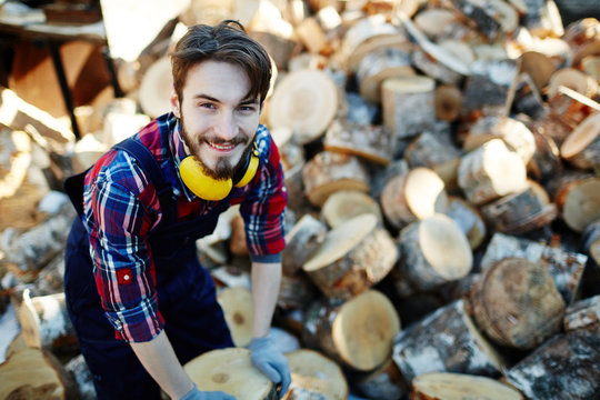 Young man working on lumberyard