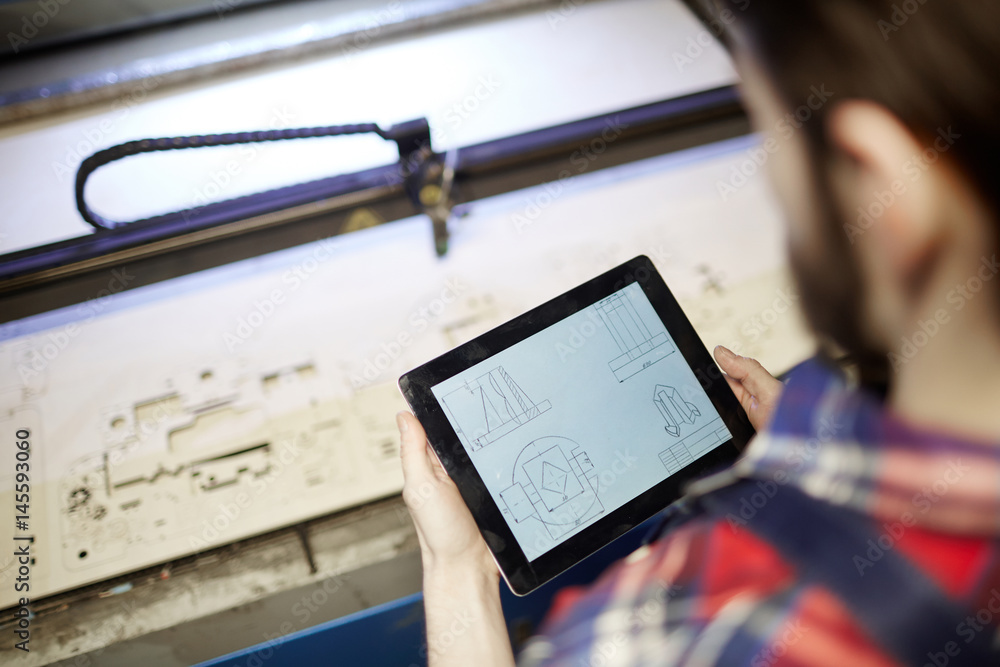 Wall mural modern engineer using sketch in touchpad during work