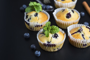 Blueberry muffins with powdered sugar and fresh berries