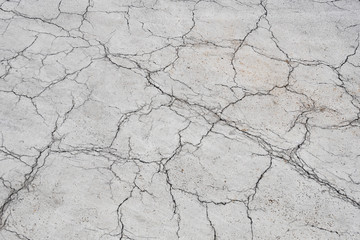 Texture of the old asphalt crosswalk cracked.