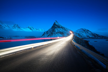 Olstind Mount and car light. Lofoten islands? spring time, Norway