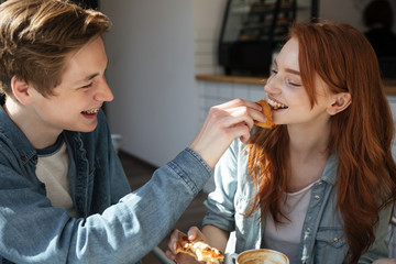 Careful boy feed his girl