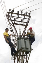 Electricians repairing wire of the power line