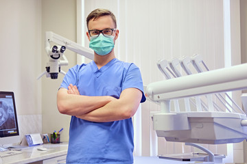 Fototapeta na wymiar Dentist in a room with medical equipment on background.