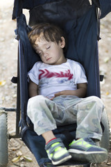 Fototapeta na wymiar Lovely Boy Sleeping in Baby Stroller