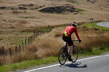 Man cycling on rural road.