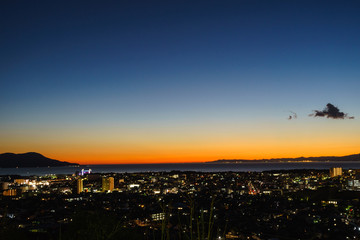 Sky stained orange and Night view of Numazu