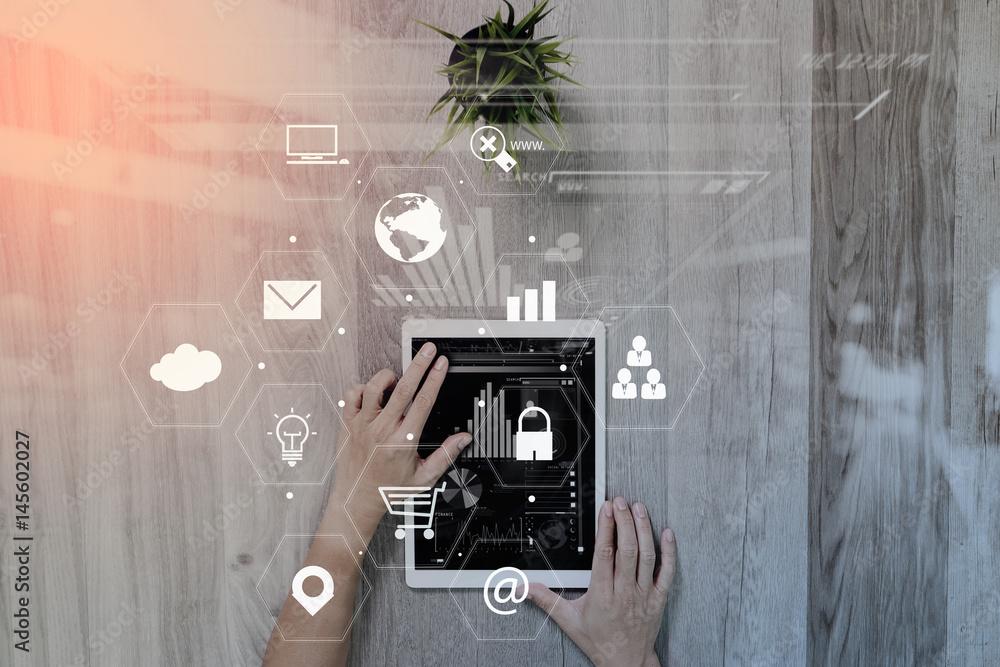 Poster businessman working with digital tablet computer on wooden desk in modern office with virtual icons 