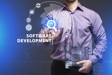 Business, Technology, Internet and network concept. Young businessman working on a virtual screen of the future and sees the inscription: Software development