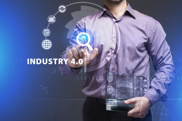 Business, Technology, Internet and network concept. Young businessman working on a virtual screen of the future and sees the inscription: Industry 4.0