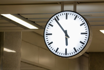 white clock hanging from ceiling, concept : hurry in early morning